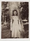 Young woman in front of tree